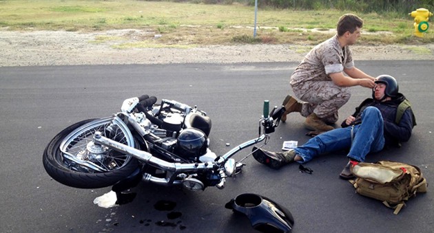 A person getting accident on the road with bike