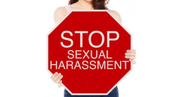 Girl holding stop sexual harassment board